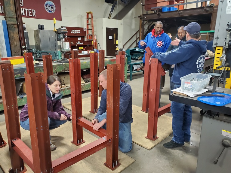 Pre-apprenticeship students at ironworkers training facility constructing a building frame