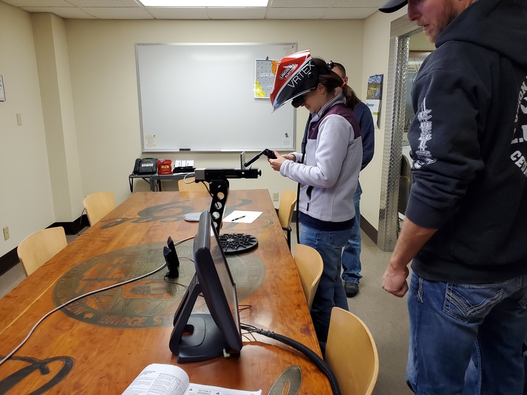 Preapprenticeship students at ironworkers training facility engaged in virtual welding simulation
