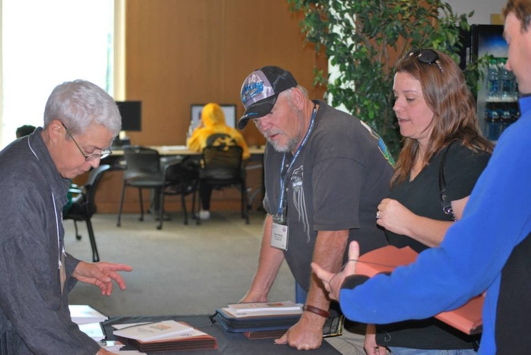 retired secretary Sarah Clark checking participants in at a Labor Center school